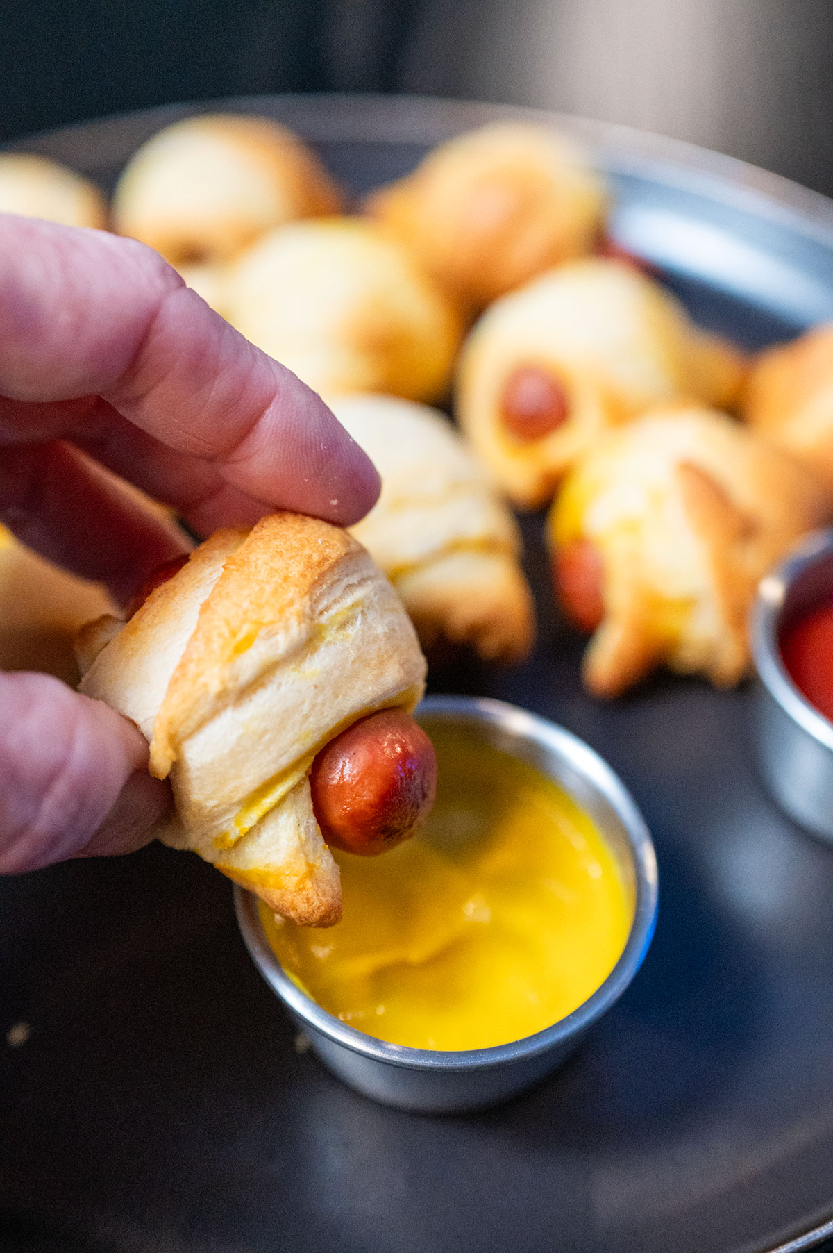 Pigs in a blanket dipped in mustard.